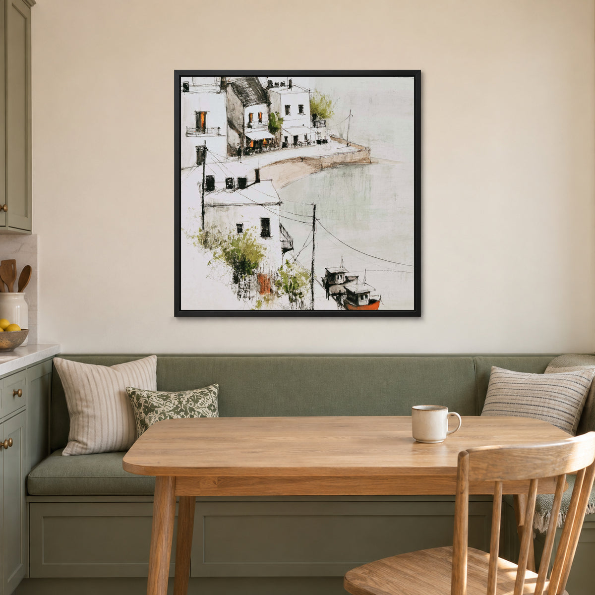 Harbour Cafe Two Boats framed canvas in a black floating frame above a green banquette and wooden table in a breakfast nook