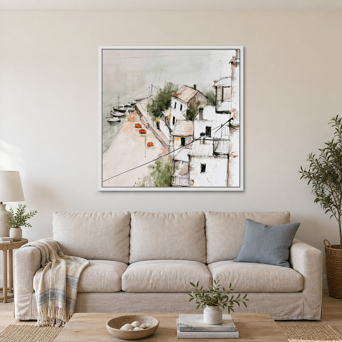 Harbour Houses Above the Quay framed canvas in a white floating frame above a linen sofa with a blue cushion