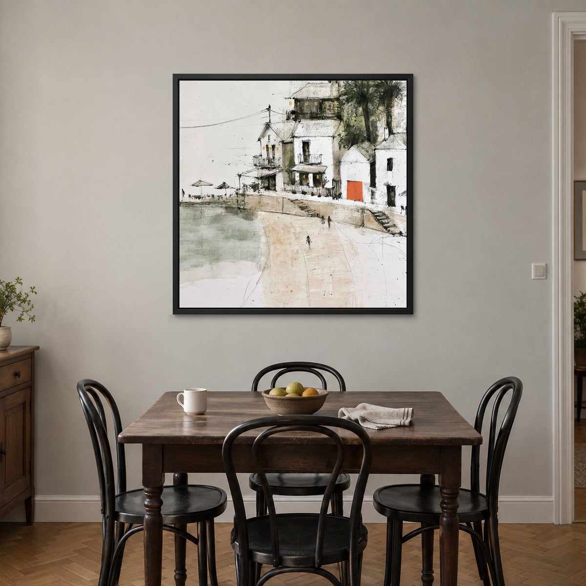 The Orange Door framed canvas in a black floating frame above a small wooden dining table with black bentwood chairs