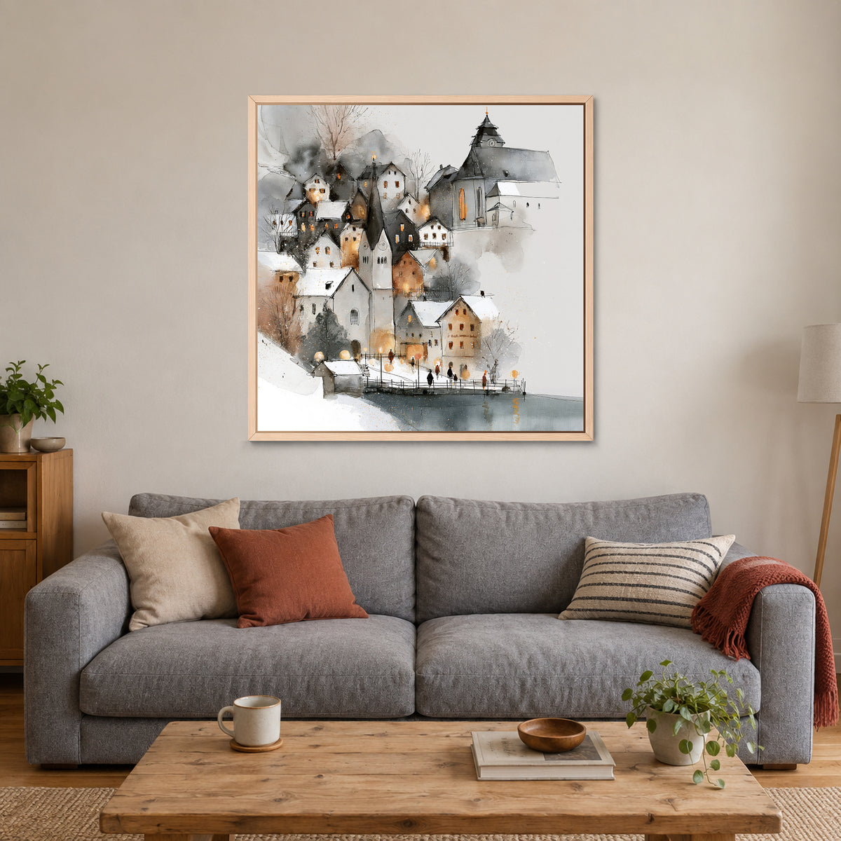 Hallstatt Waterfront Clock Tower framed canvas in a natural wood floating frame above a grey sofa with rust and striped cushions