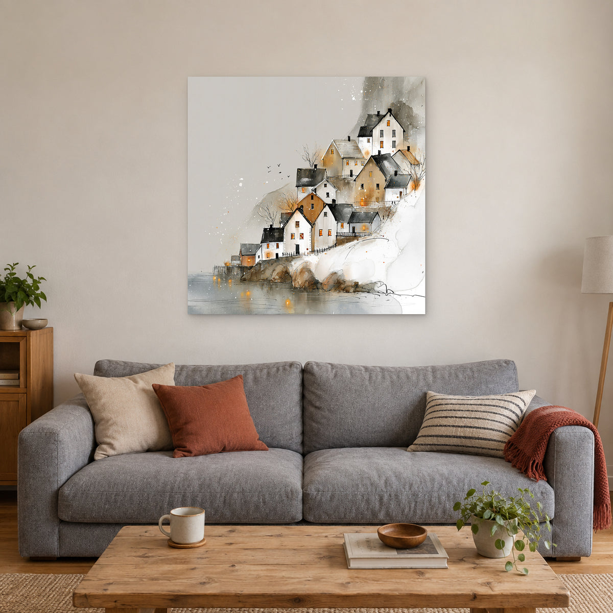 Reine Norway Houses Above Still Water canvas wall art above a grey sofa with rust and striped cushions