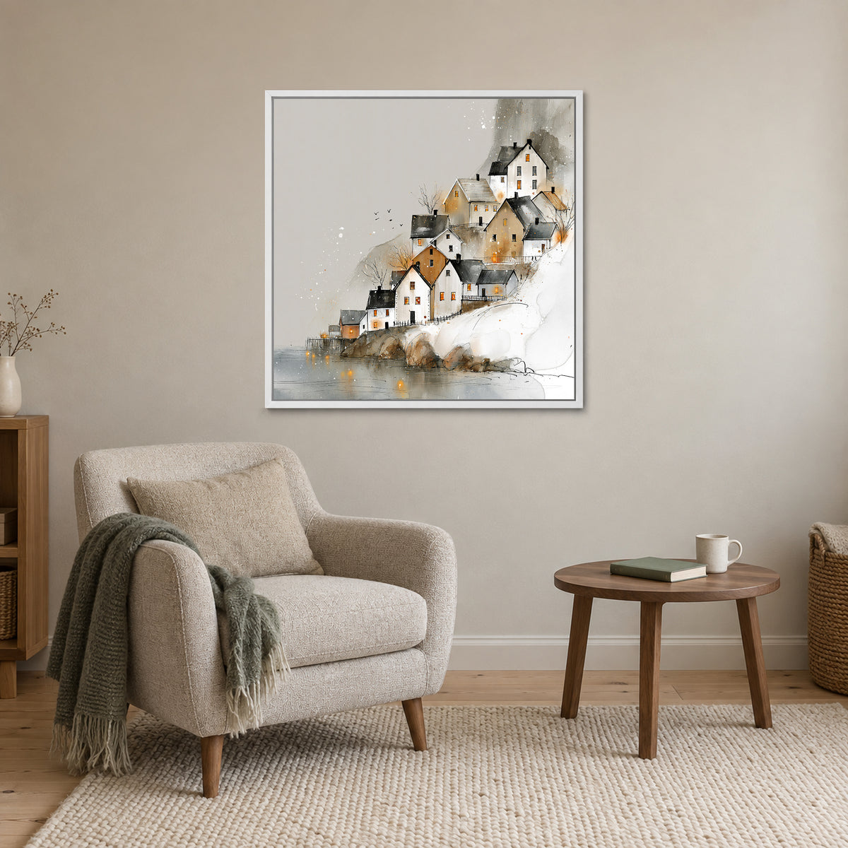 Reine Norway Houses Above Still Water framed canvas in a white floating frame above a cream armchair and round wooden side table