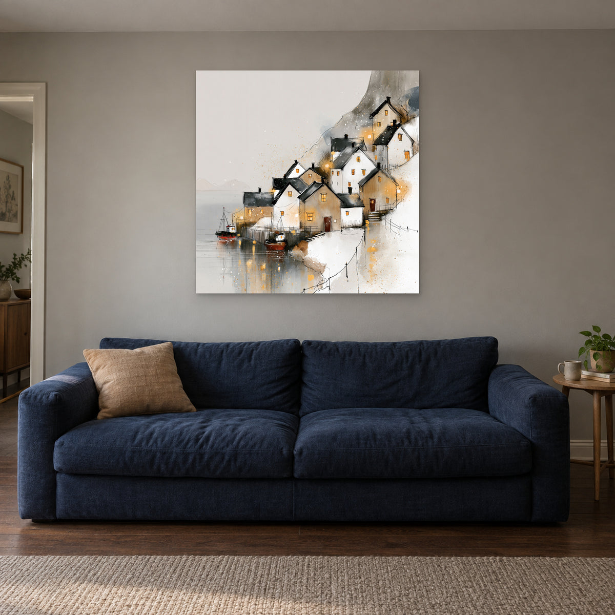 Harbour Lights in the Snow canvas wall art above a navy sofa in a living room