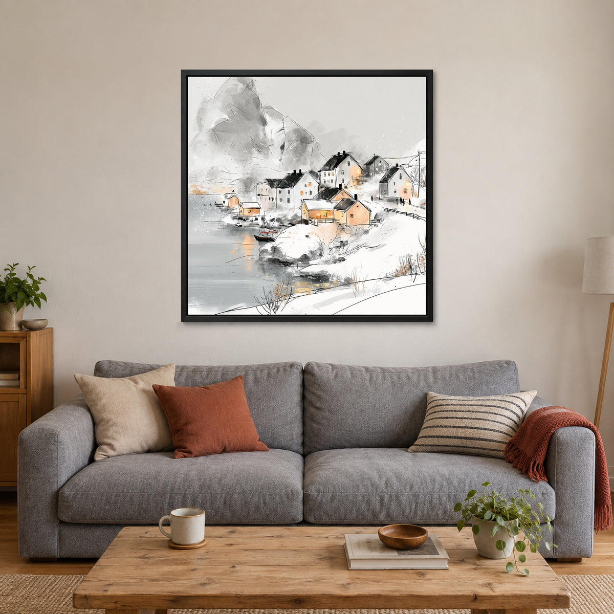 Snowy Nordic Harbour Village framed canvas in a black floating frame above a grey sofa with rust and striped cushions