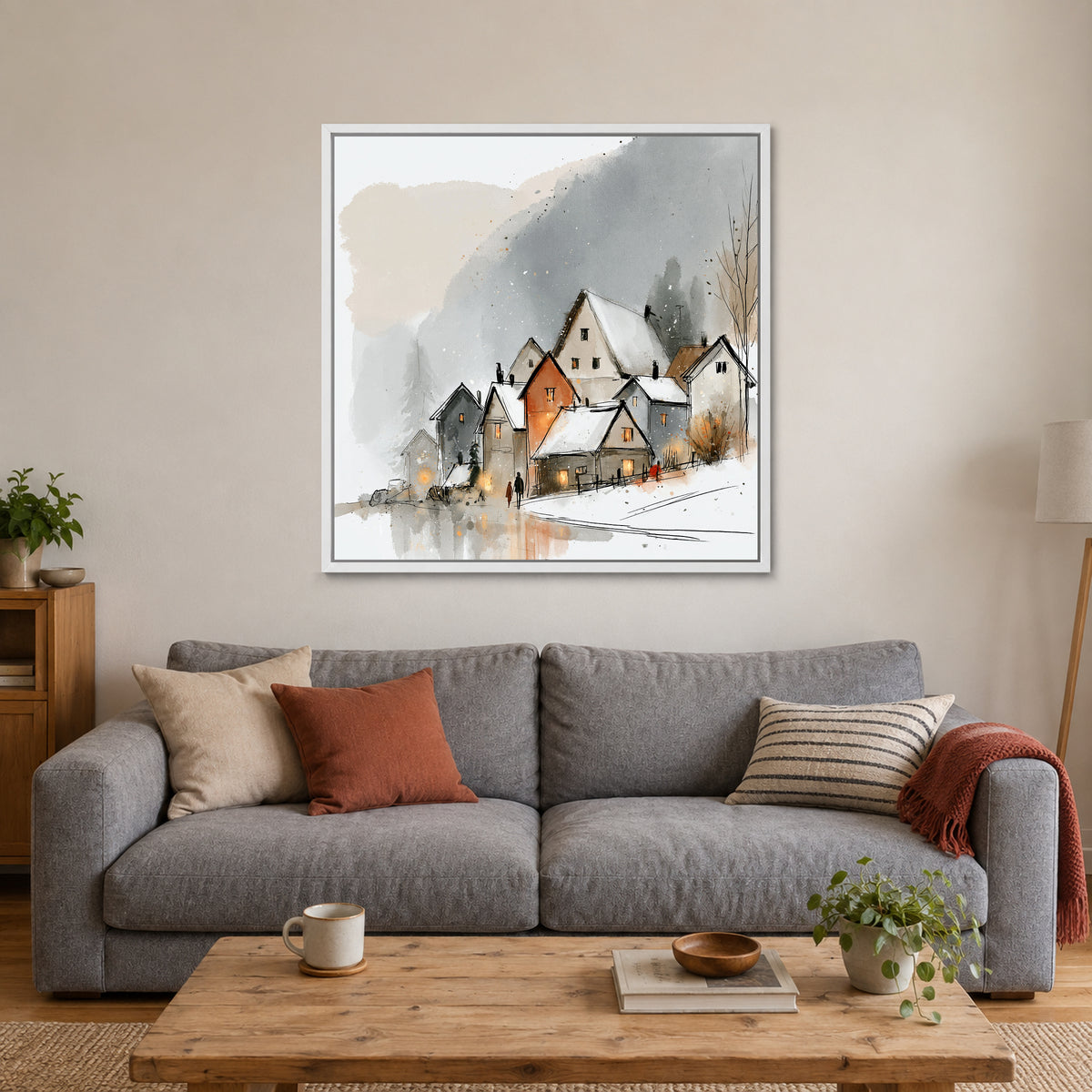 Shirakawa-go Farmhouses in Snow framed canvas in a white floating frame above a grey sofa with rust and striped cushions