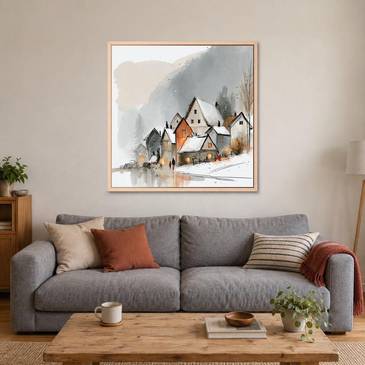 Shirakawa-go Farmhouses in Snow framed canvas in a natural wood floating frame above a grey sofa with rust and striped cushions