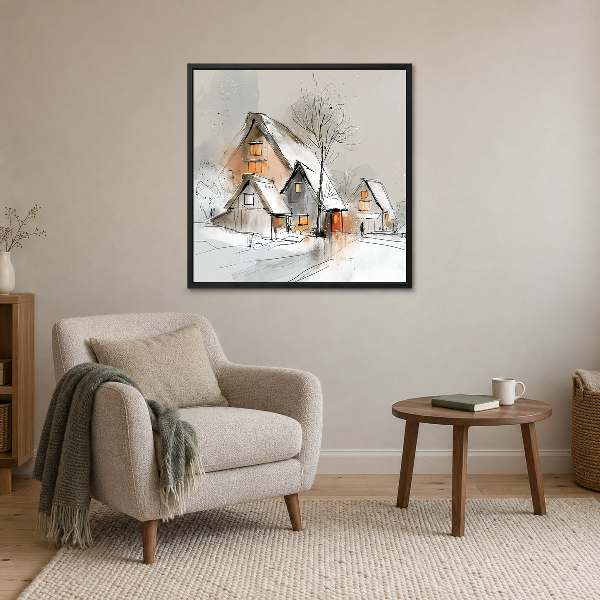 Three Thatched Roofs and a Tree framed canvas in a black floating frame above a cream armchair and round wooden side table