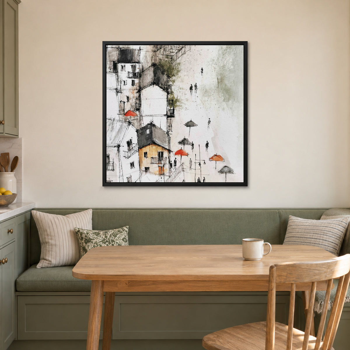 Sicilian Hill Town Pen and Wash framed canvas in a black floating frame above a green banquette and wooden table in a breakfast nook