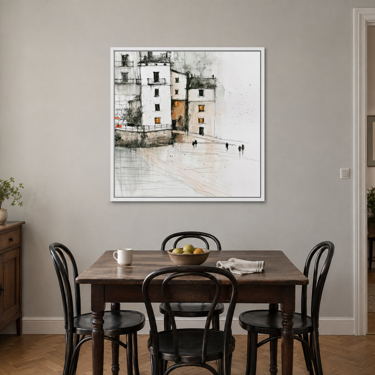 Sicilian Quay in Pencil and Ink framed canvas in a white floating frame above a small wooden dining table with black bentwood chairs