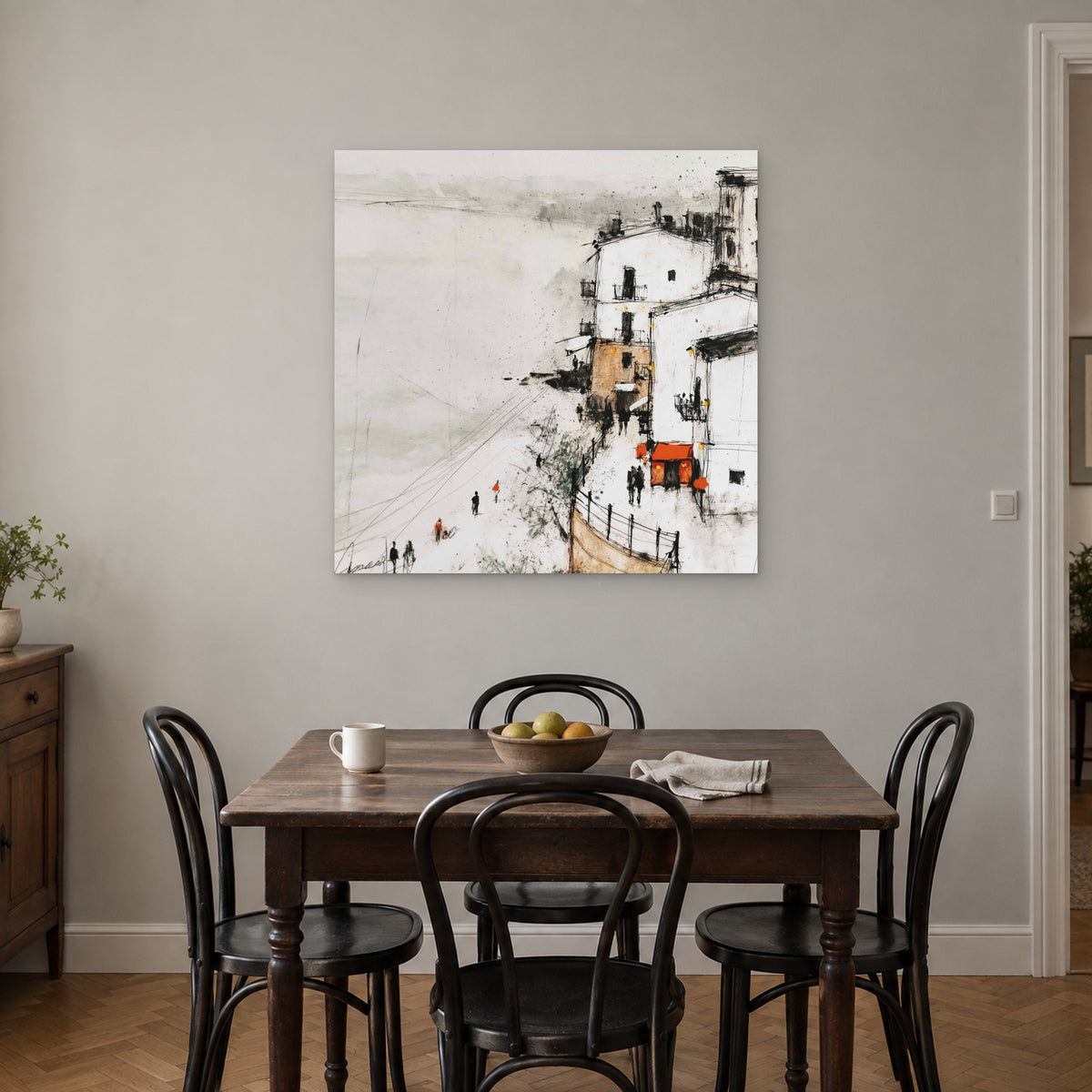 Sicilian Cliff Town Above the Sand canvas wall art above a small wooden dining table with black bentwood chairs