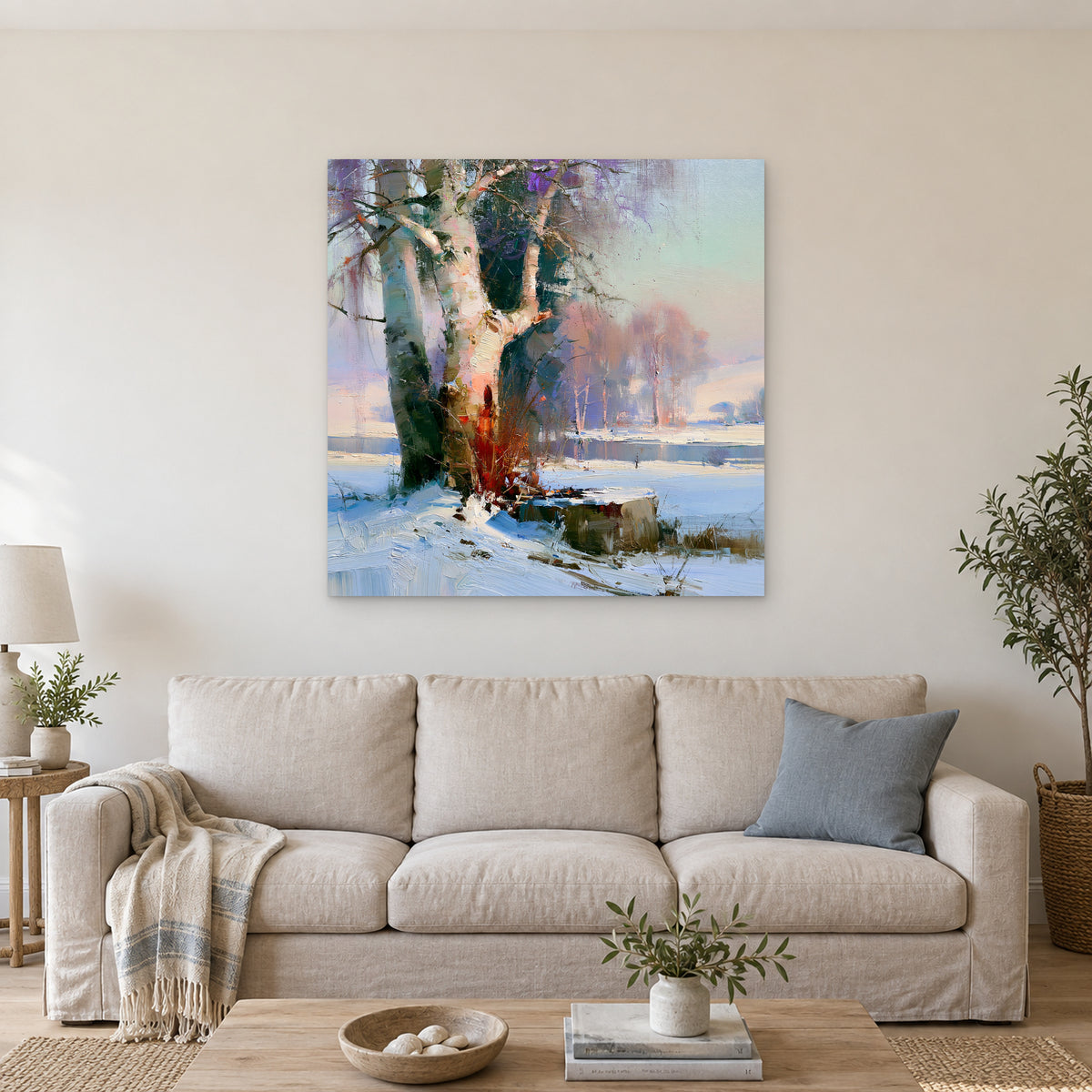 Birches on the Frozen River canvas wall art above a linen sofa with a blue cushion in a bright living room