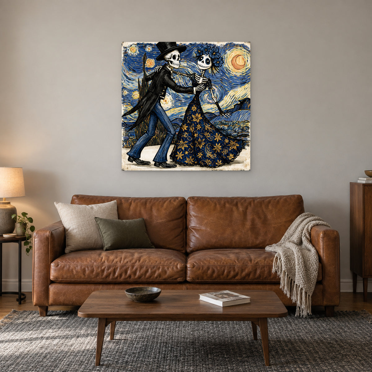 Skeletons Dancing Under Stars canvas wall art above a cognac leather sofa with a wooden coffee table