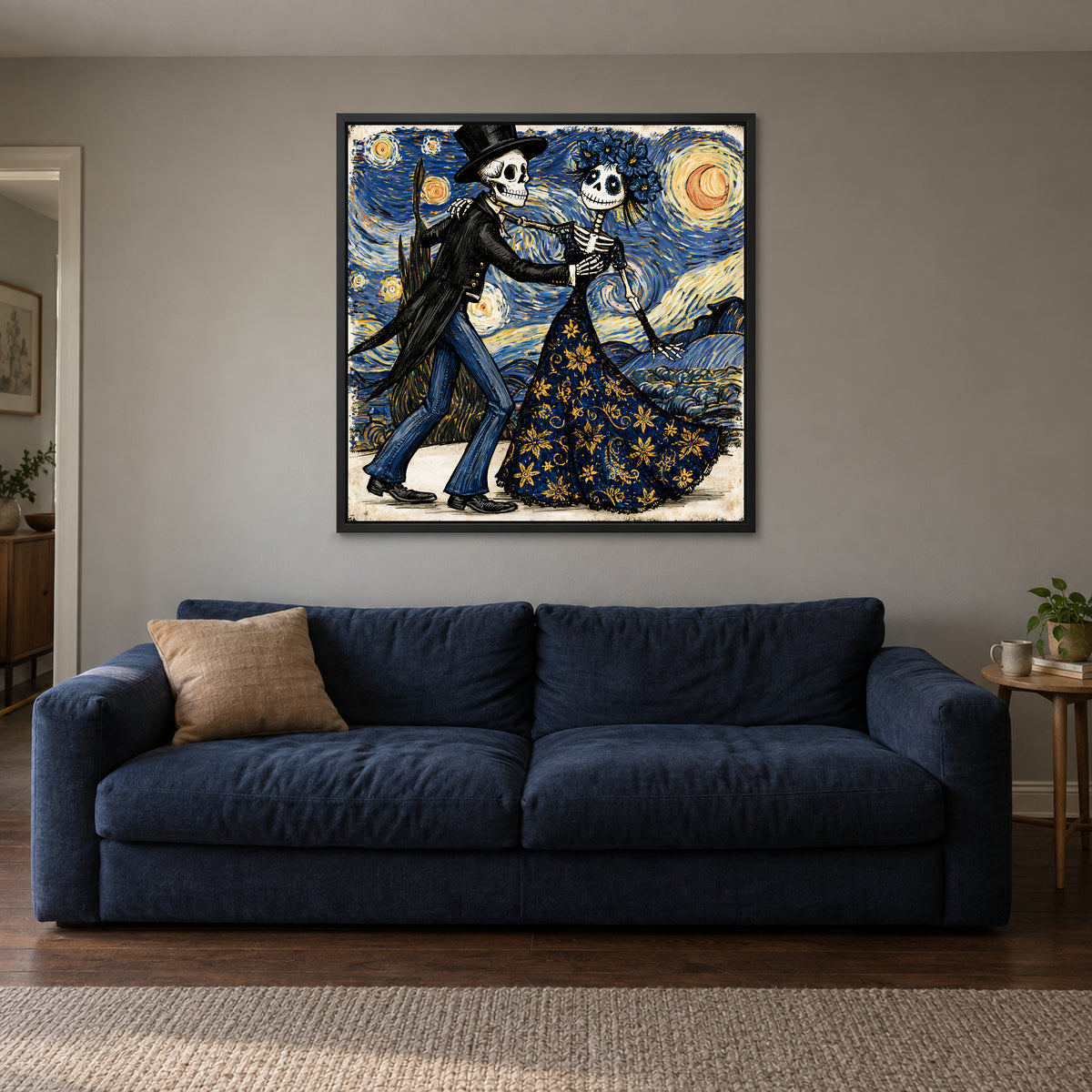 Skeletons Dancing Under Stars framed canvas in a black floating frame above a navy sofa