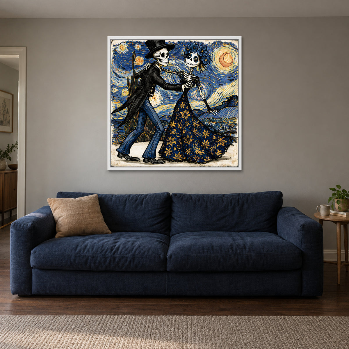 Skeletons Dancing Under Stars framed canvas in a white floating frame above a navy sofa