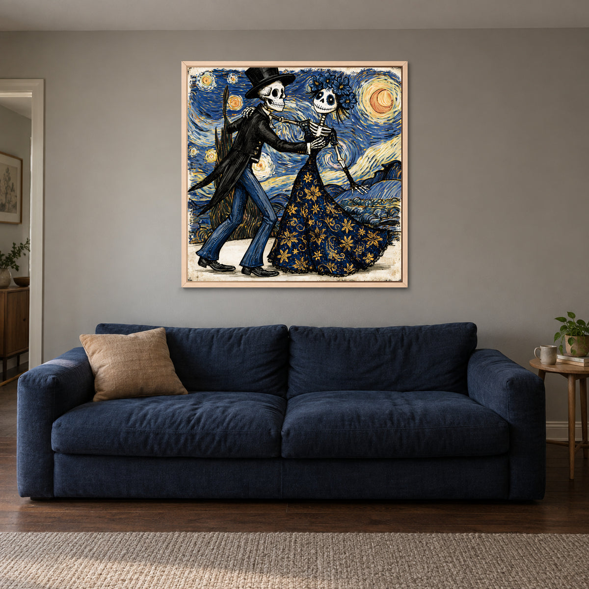 Skeletons Dancing Under Stars framed canvas in a natural wood floating frame above a navy sofa