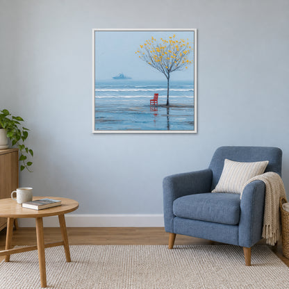 A Red Chair by the Sea framed canvas in a white floating frame above a blue armchair and round wooden side table