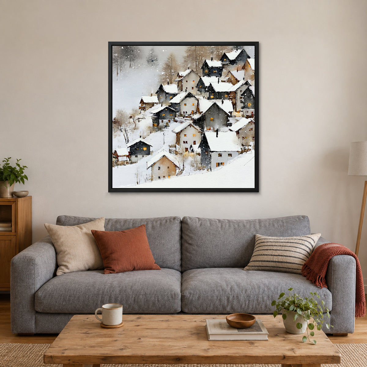 Alpine Chalets in Heavy Snow framed canvas in a black floating frame above a grey sofa with rust and striped cushions