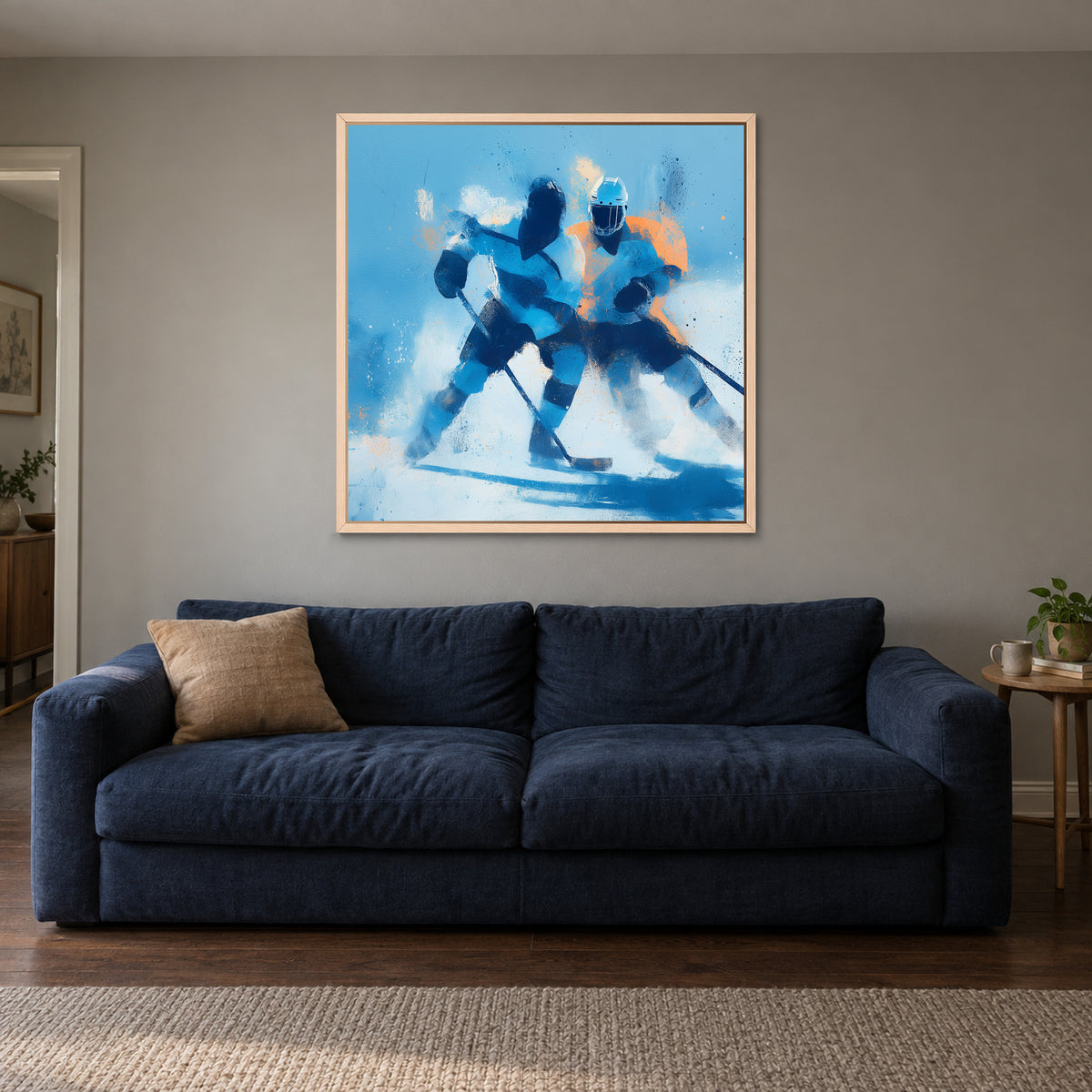 Hockey Chasing the Puck framed canvas in a natural wood floating frame above a navy sofa