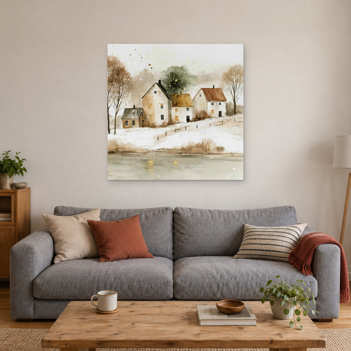Farmhouses Above the Frozen Pond canvas wall art above a grey sofa with rust and striped cushions