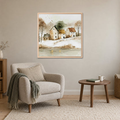 Farmhouses Above the Frozen Pond framed canvas in a natural wood floating frame above a cream armchair and round wooden side table