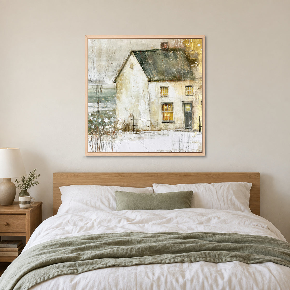 A Single Lit Farmhouse framed canvas in a natural wood floating frame above a bed with white linens and a sage throw