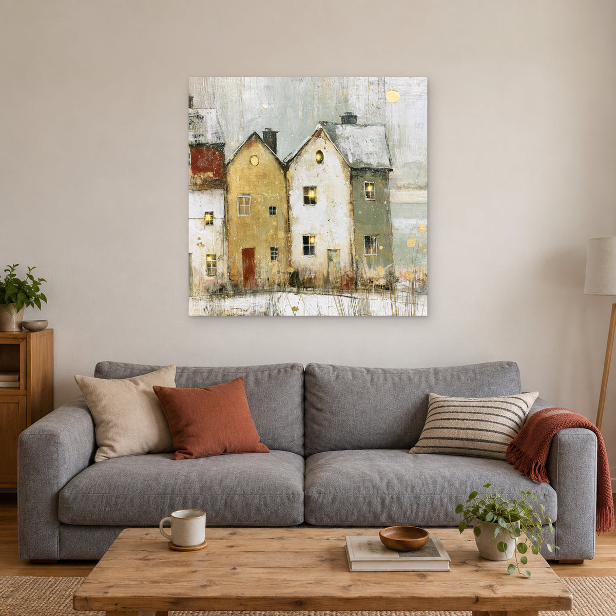 Two Gables Round Attic Windows canvas wall art above a grey sofa with rust and striped cushions