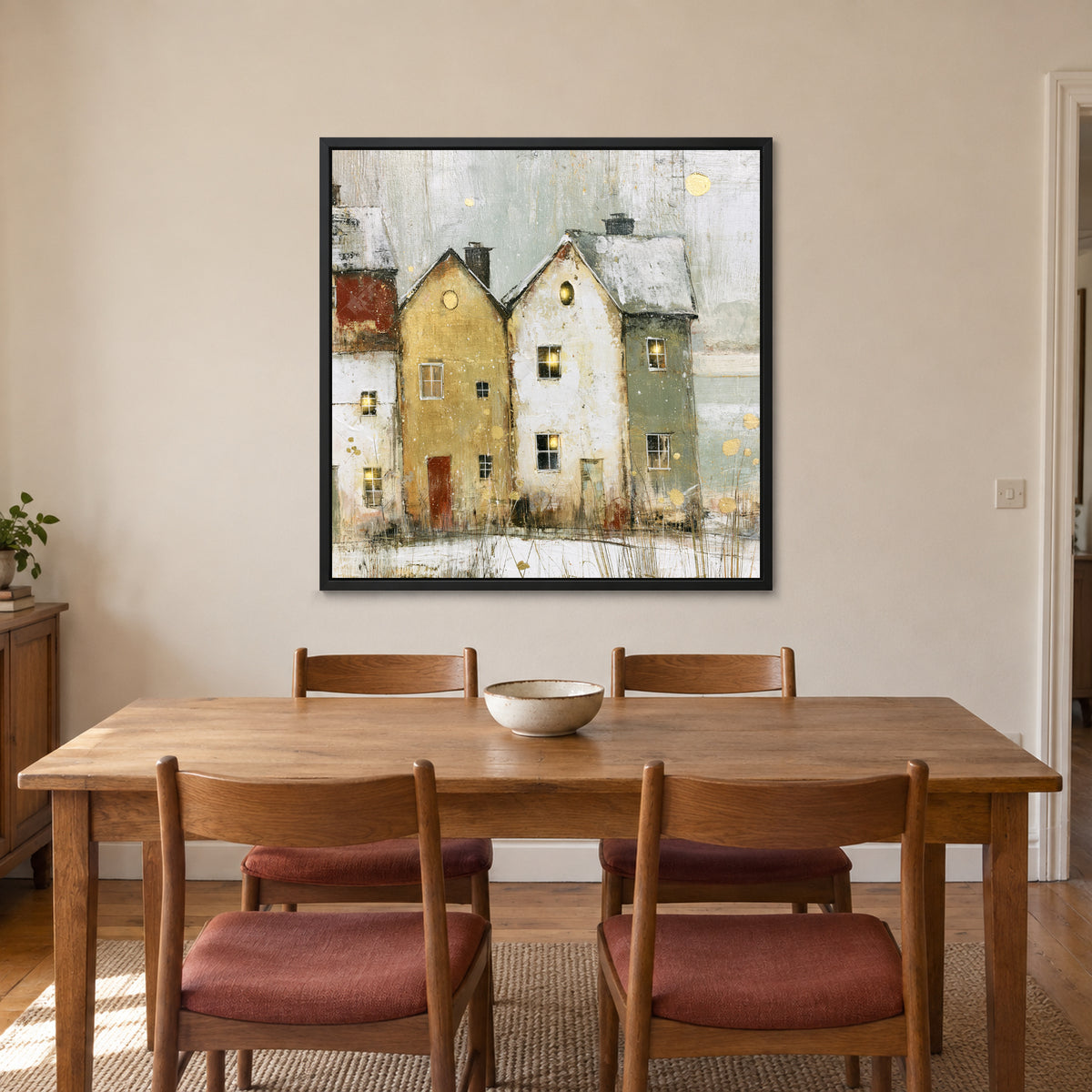 Two Gables Round Attic Windows framed canvas in a black floating frame above a wooden dining table with rust-cushioned chairs