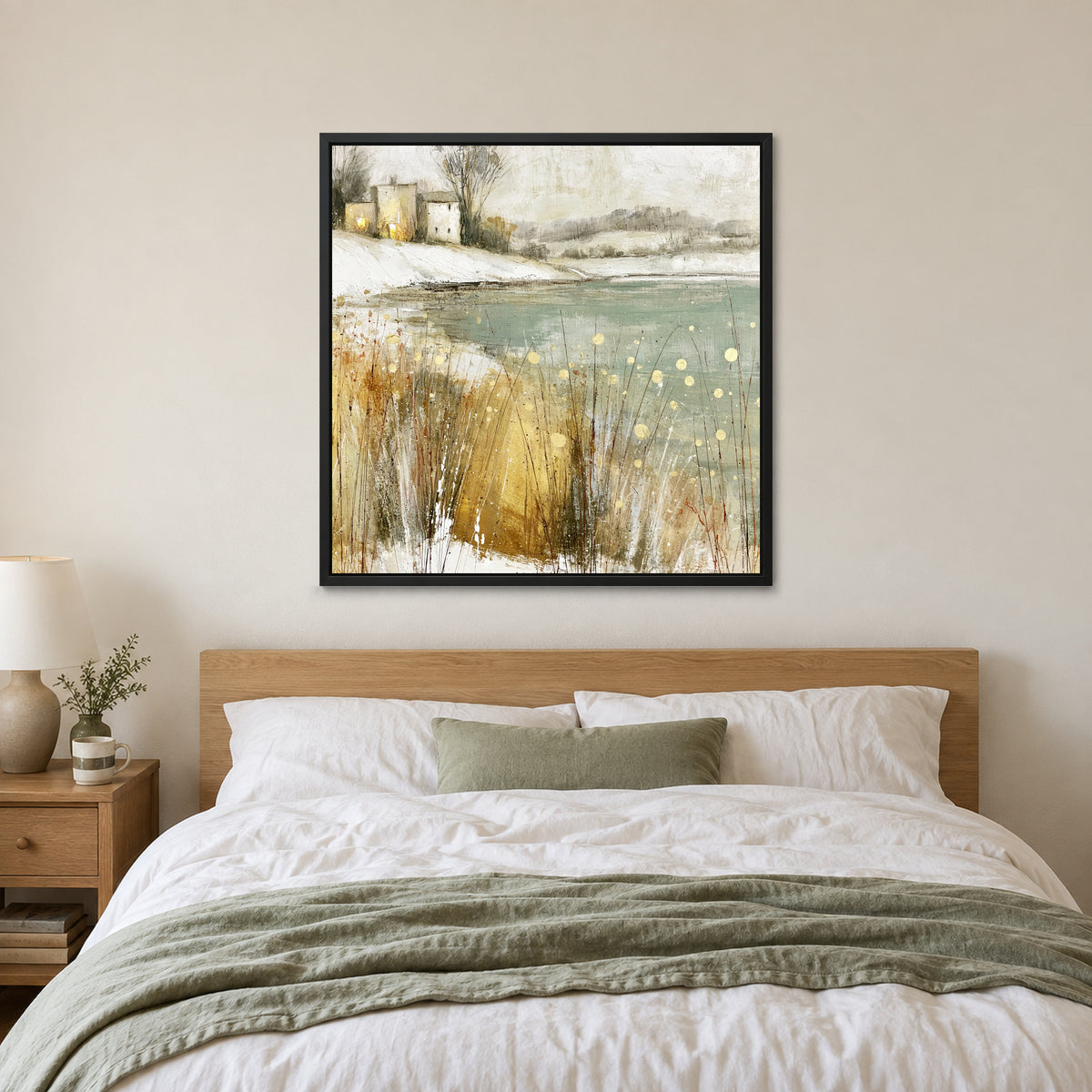 Winter Grasses and a Distant Farmhouse framed canvas in a black floating frame above a bed with white linens and a sage throw