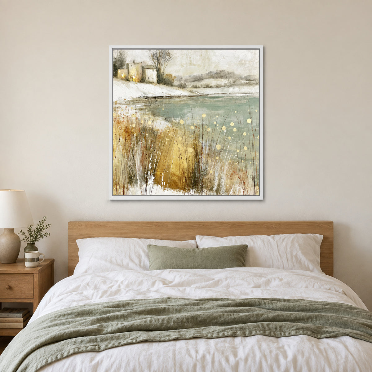 Winter Grasses and a Distant Farmhouse framed canvas in a white floating frame above a bed with white linens and a sage throw