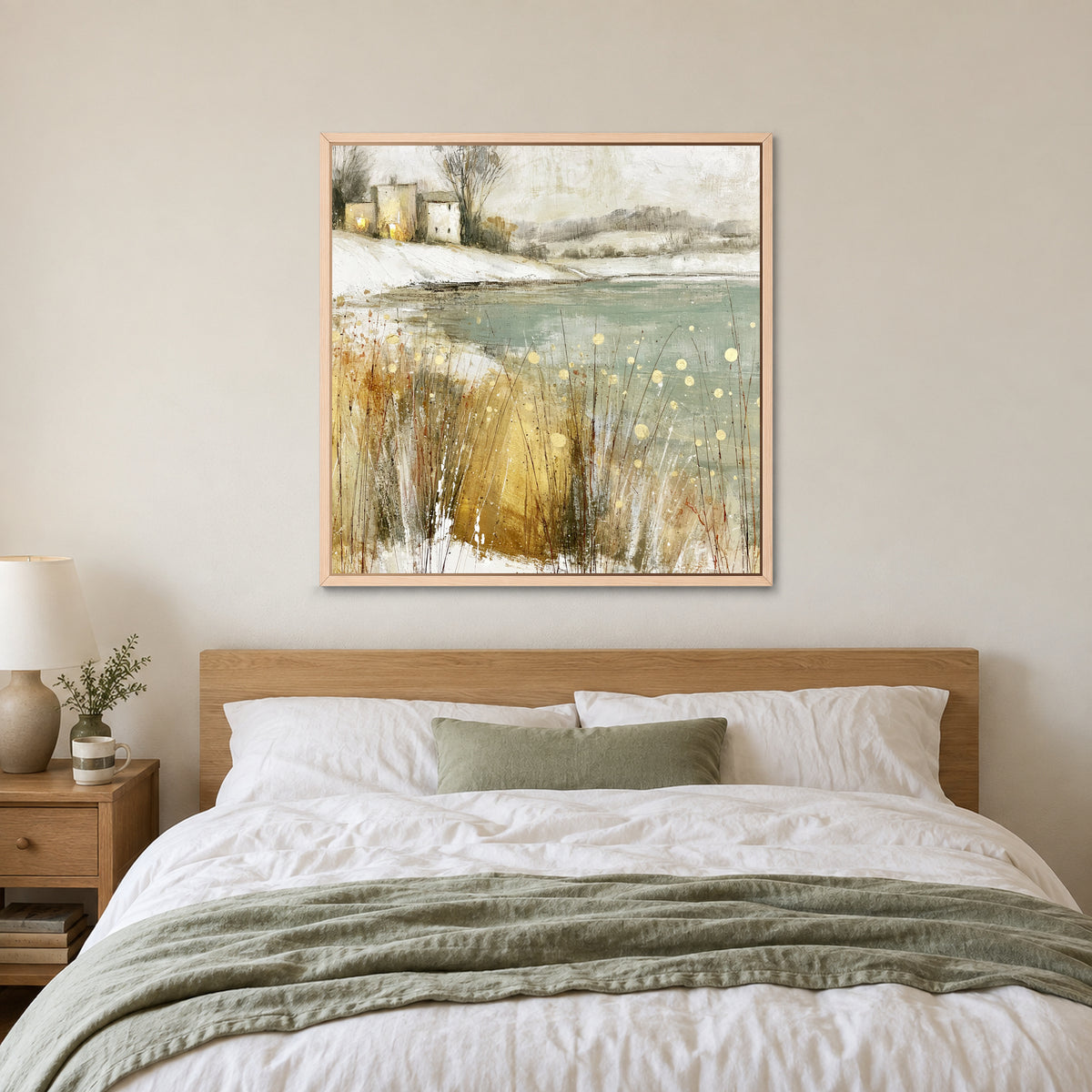 Winter Grasses and a Distant Farmhouse framed canvas in a natural wood floating frame above a bed with white linens and a sage throw