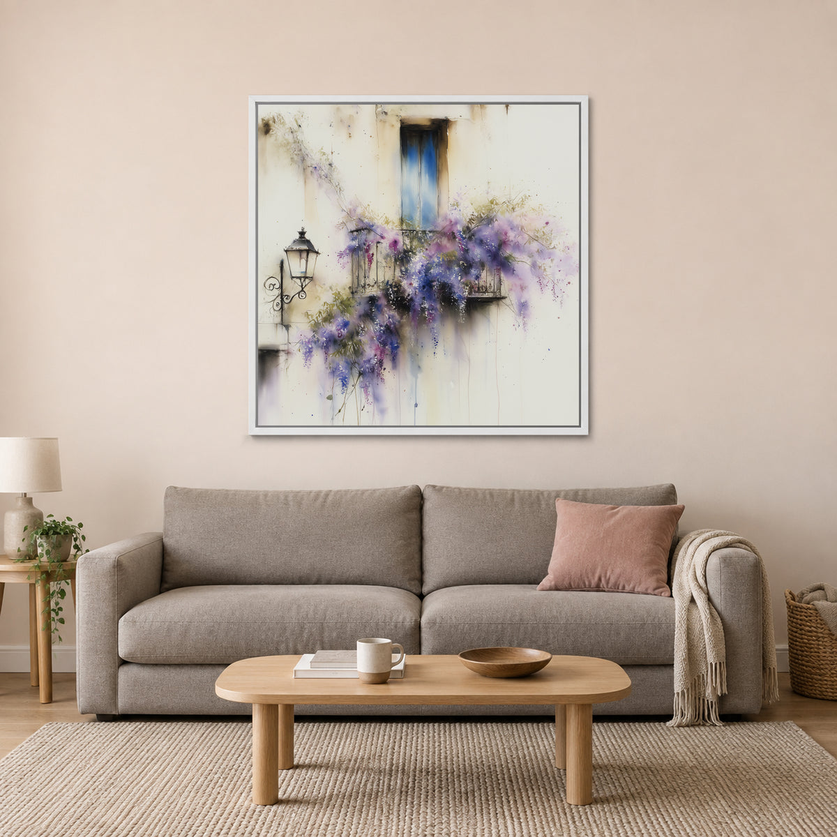 Wisteria in Full Bloom framed canvas in a white floating frame above a taupe sofa with a pink cushion and an oval wooden coffee table